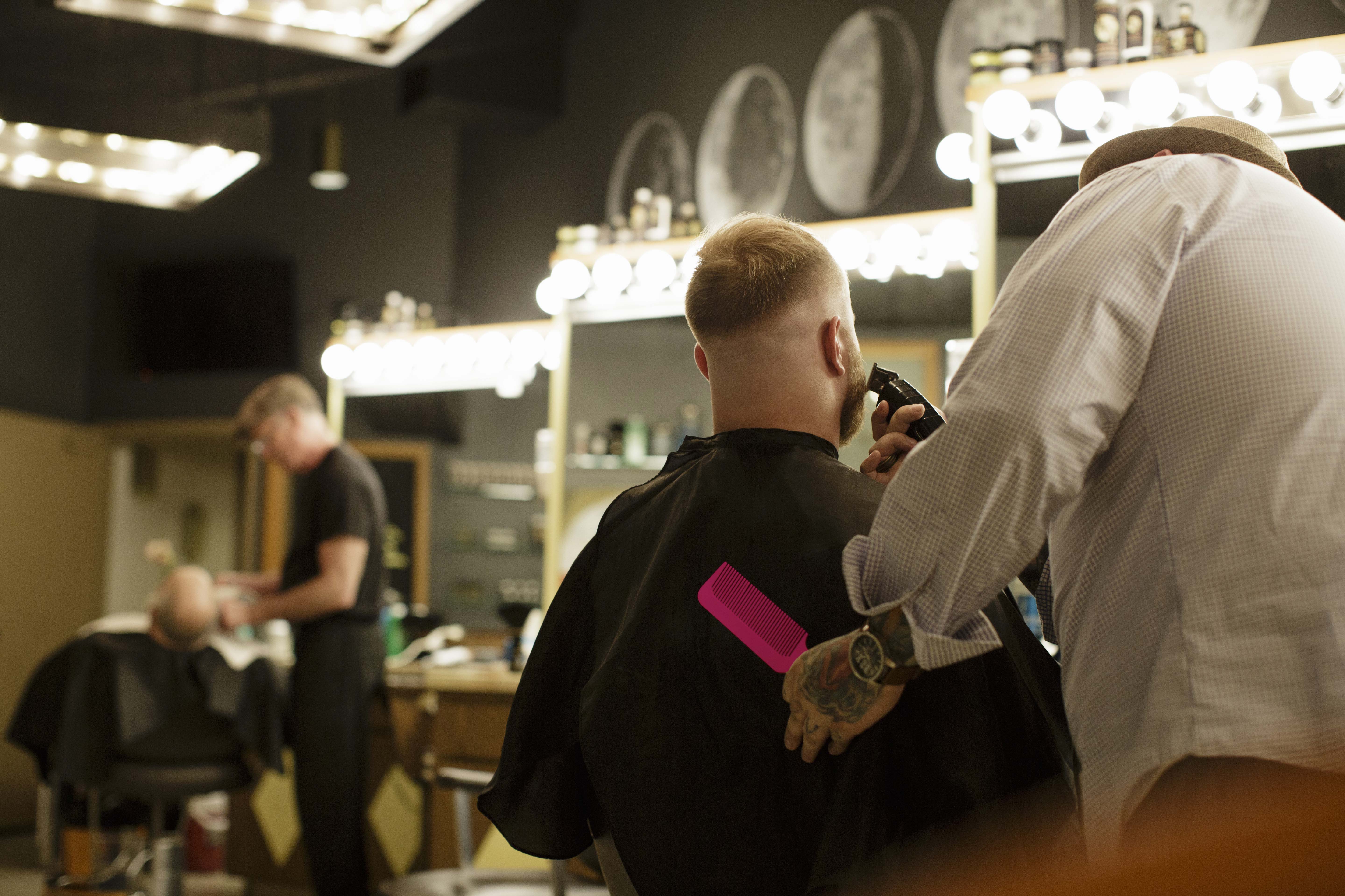 An example of a self-employed career: A barber cutting a young male’s hair.