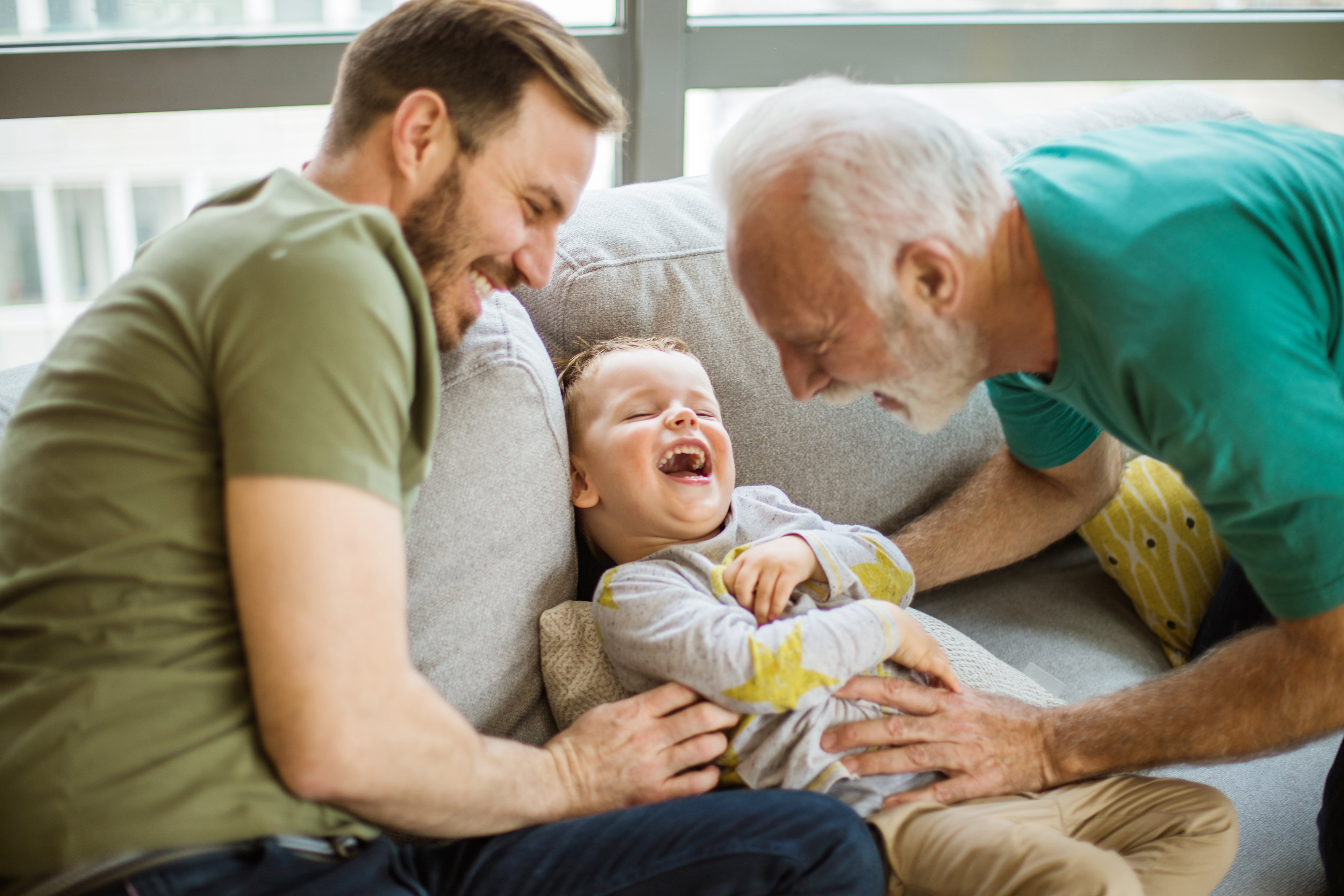 Father, son and grandfather laughing