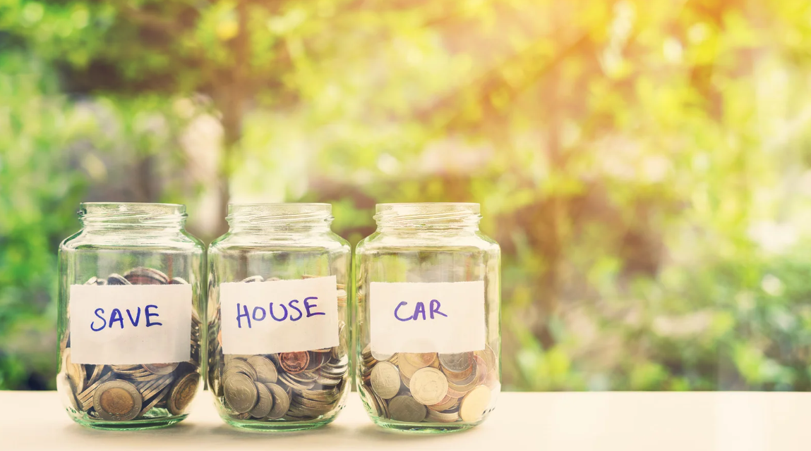 Three glass jars filled with coins