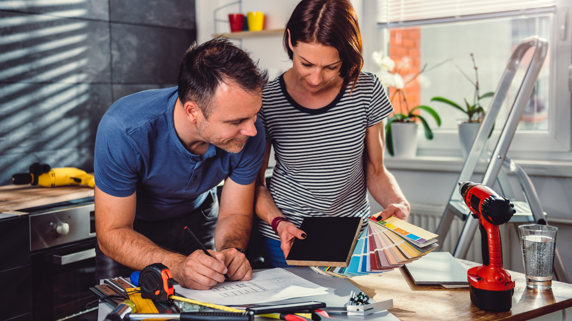 Couple looking at colour swatches and renovation plans