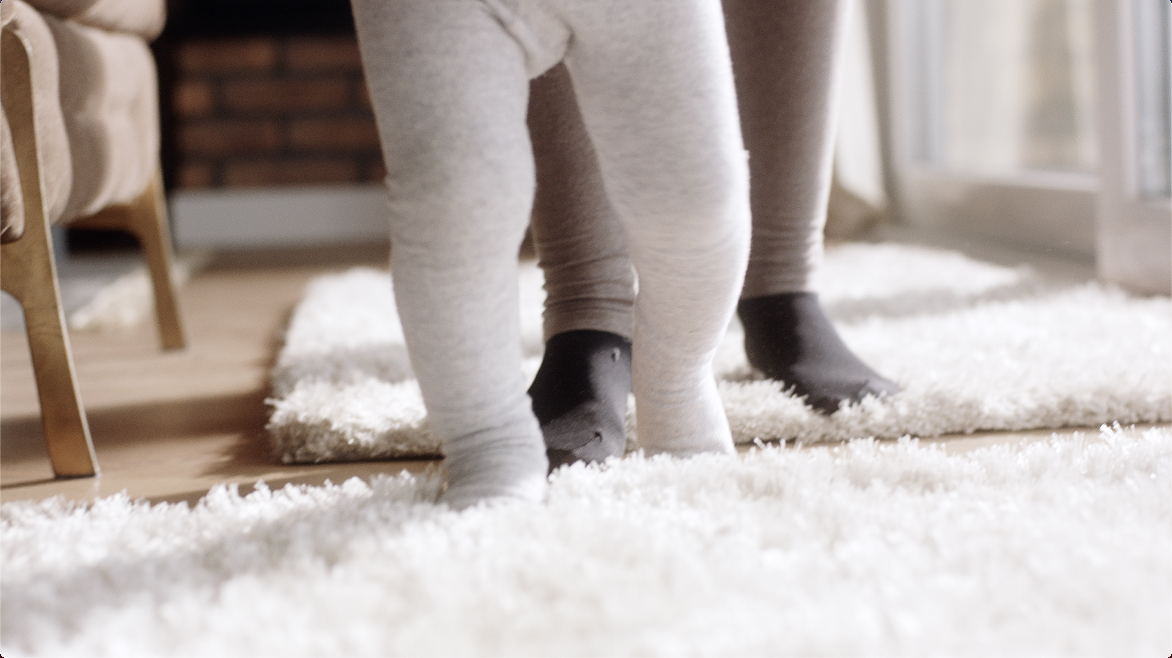 A small child walking across the floor