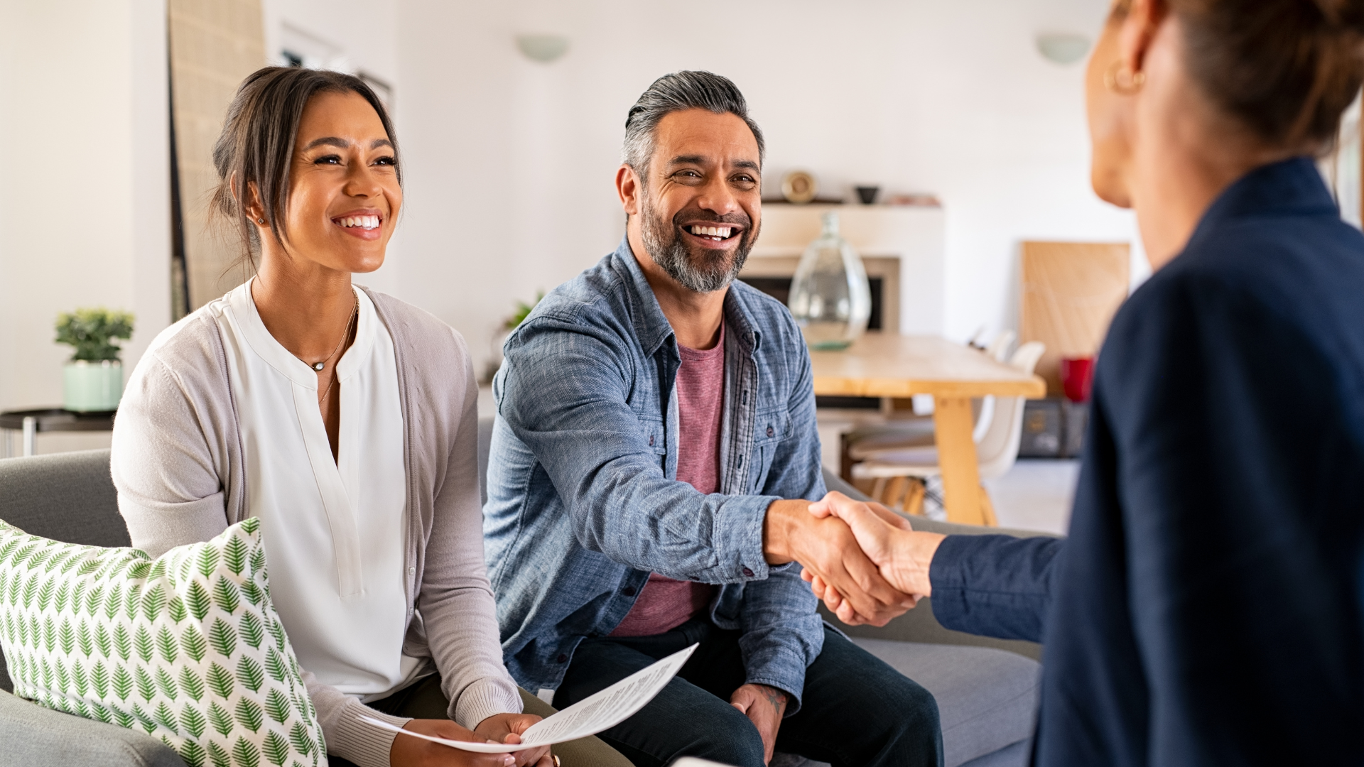 Couple shaking hands with advisor