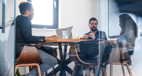 Three people having a meeting in a conference room