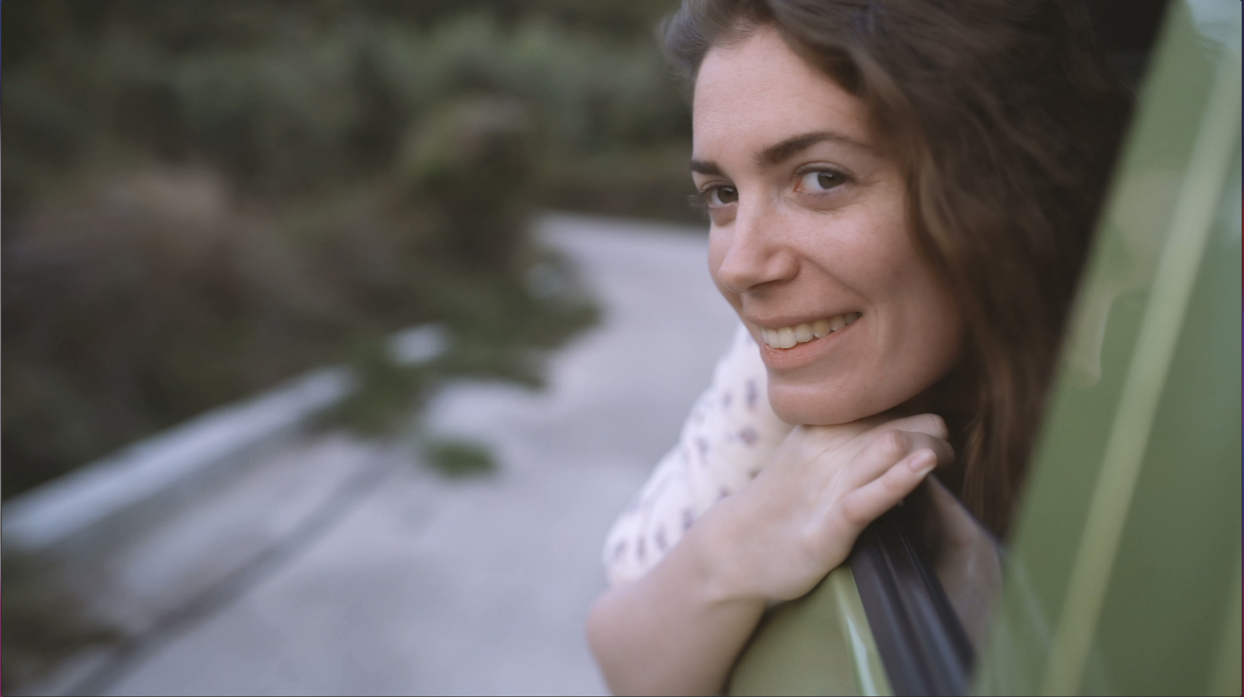 A woman with her head out of a car window