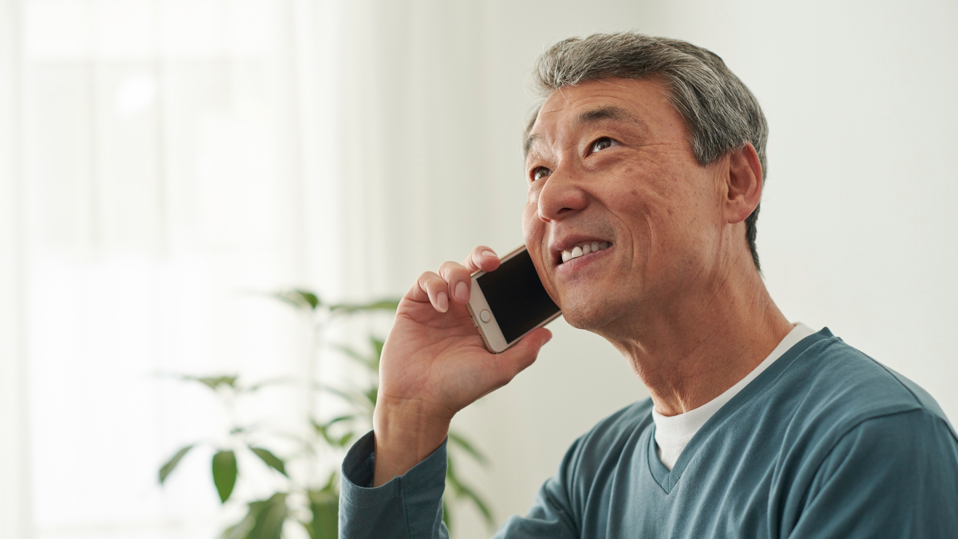 Smiling man on the phone.