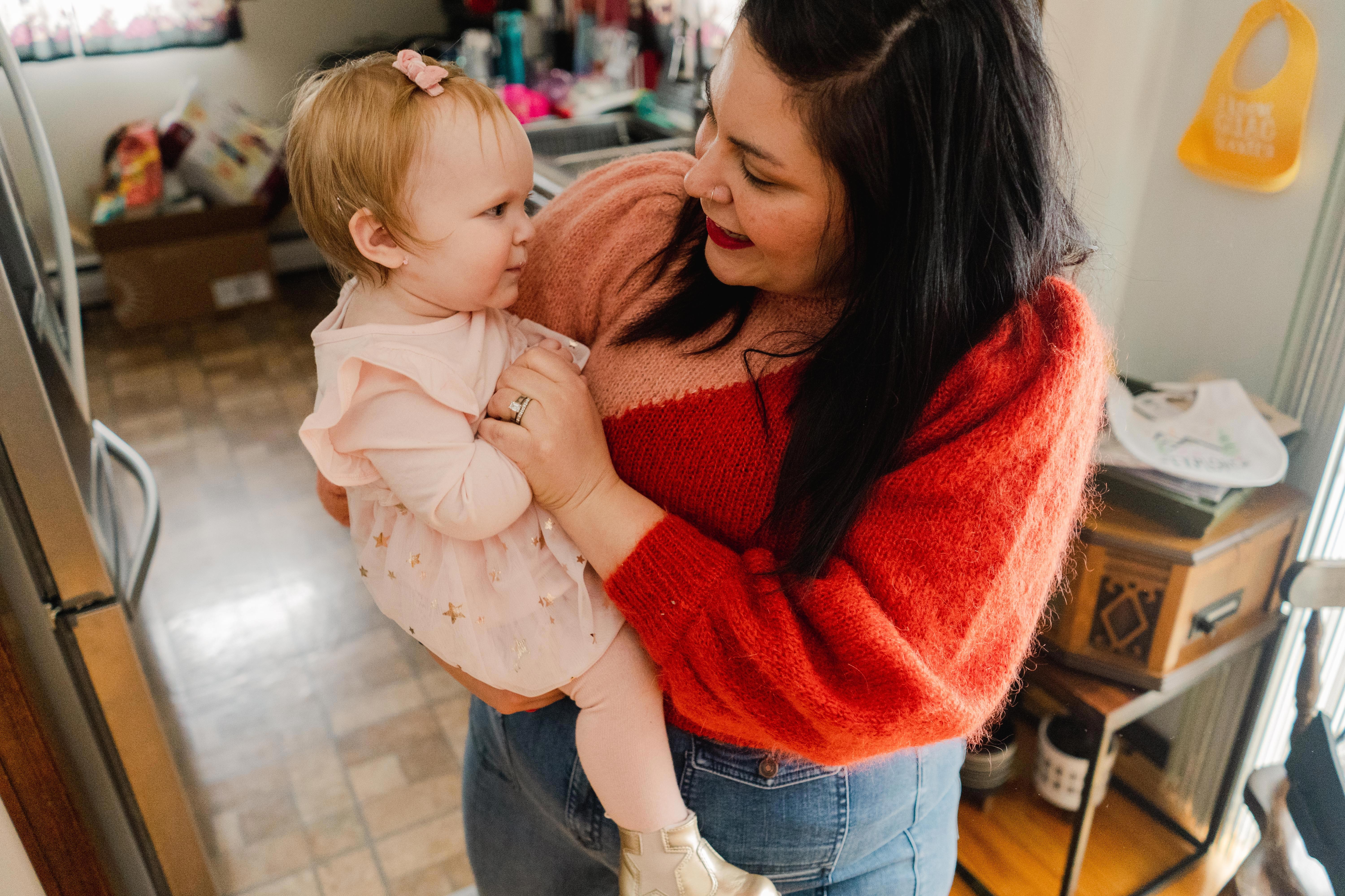 Woman holding a baby in the kitchen