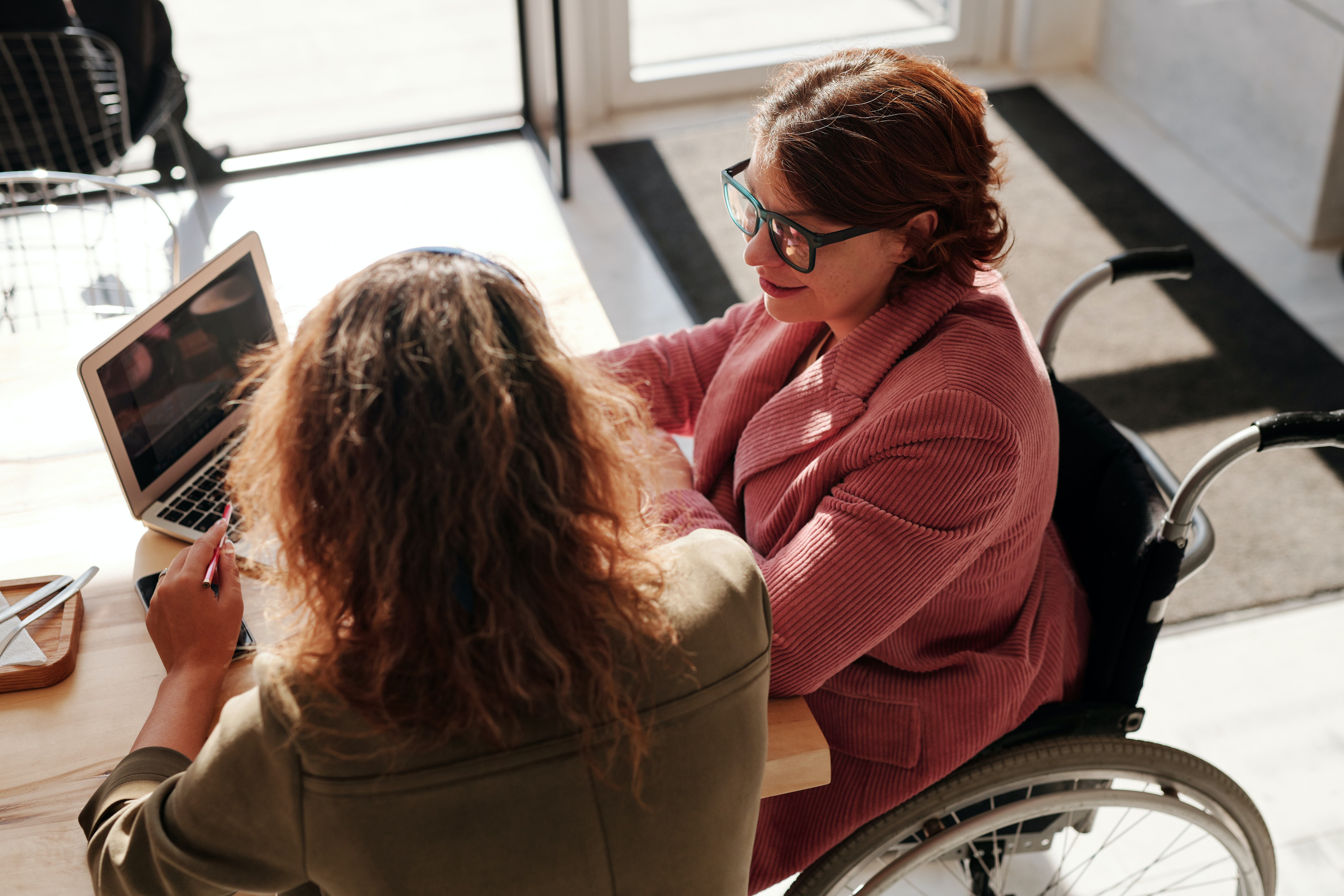 two women looking at a laptop