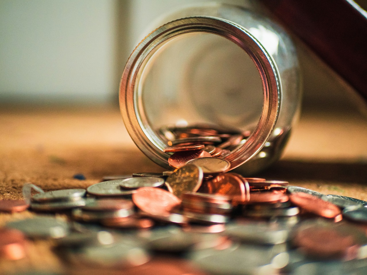 Coins spilling out of jar