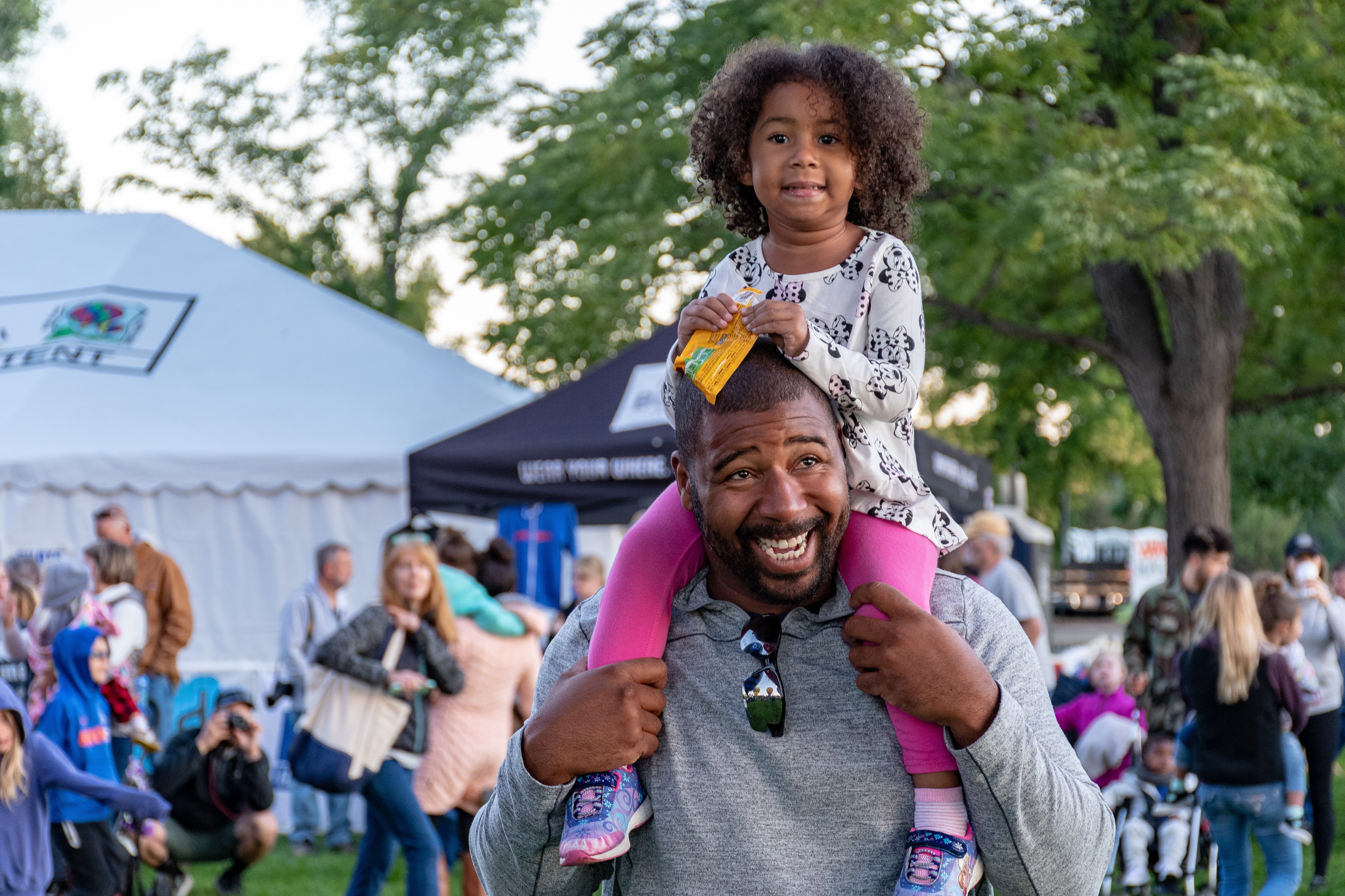 Man with daughter at summer event