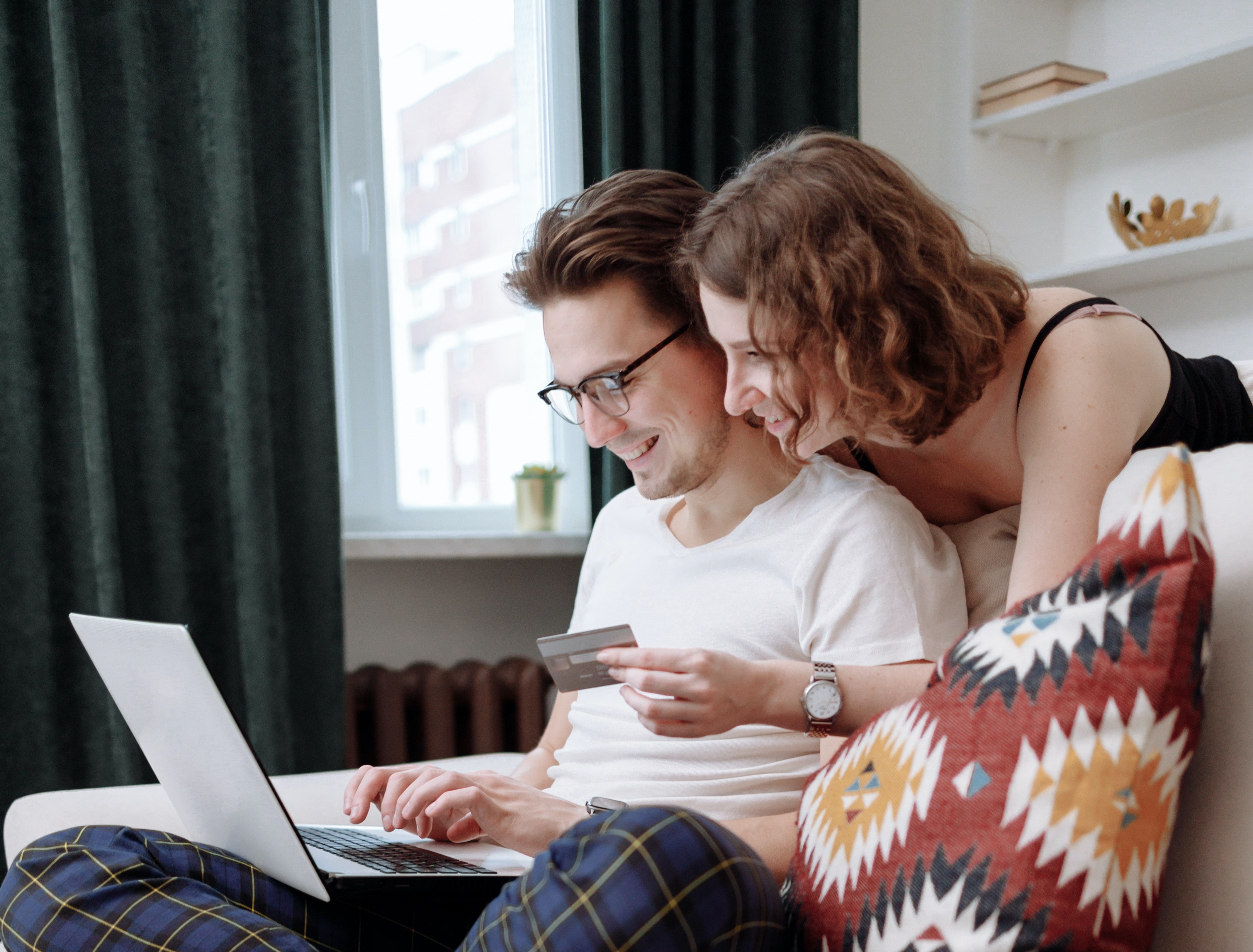 Couple reviewing their spending on a laptop