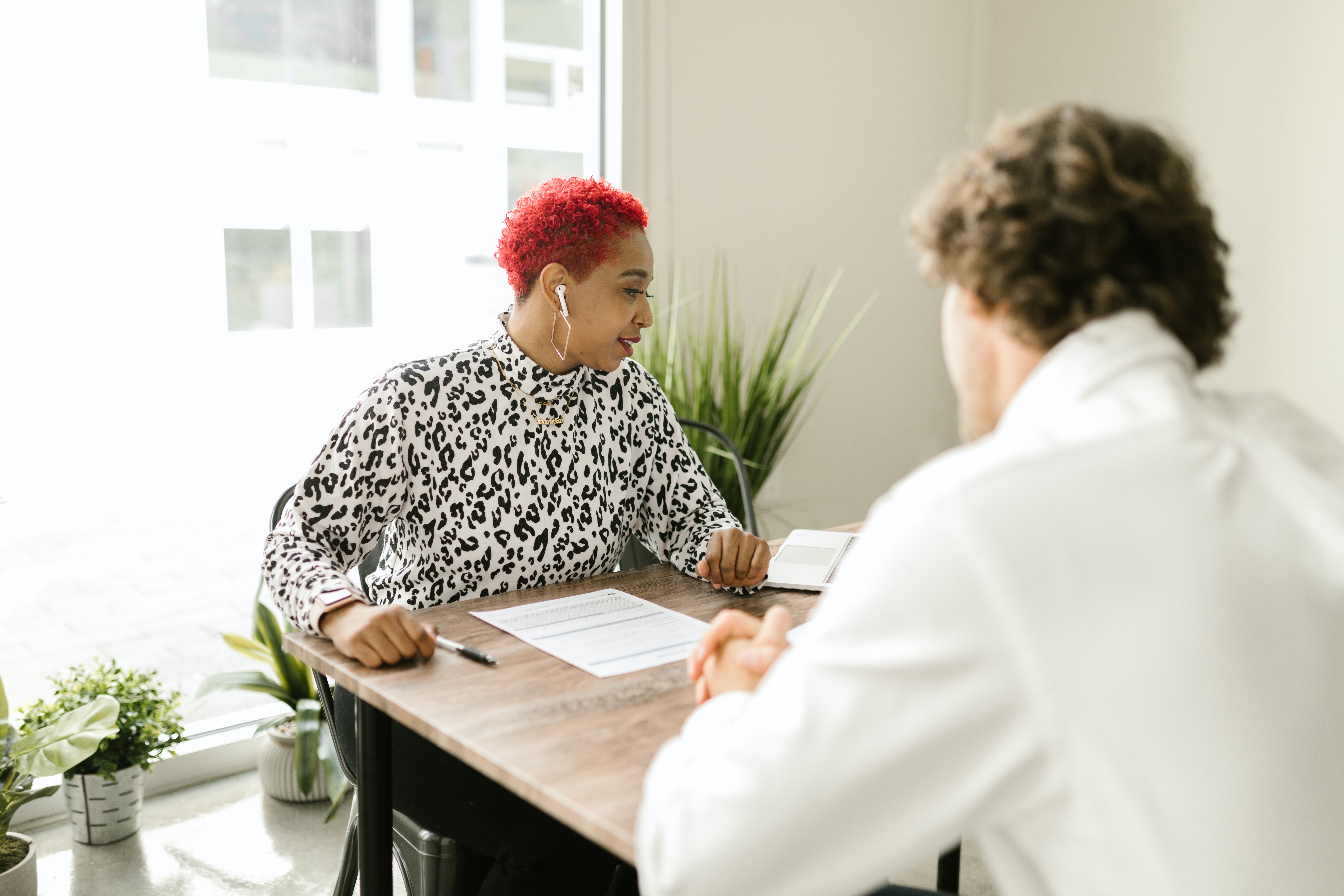 Two people in conversation sitting at a desk