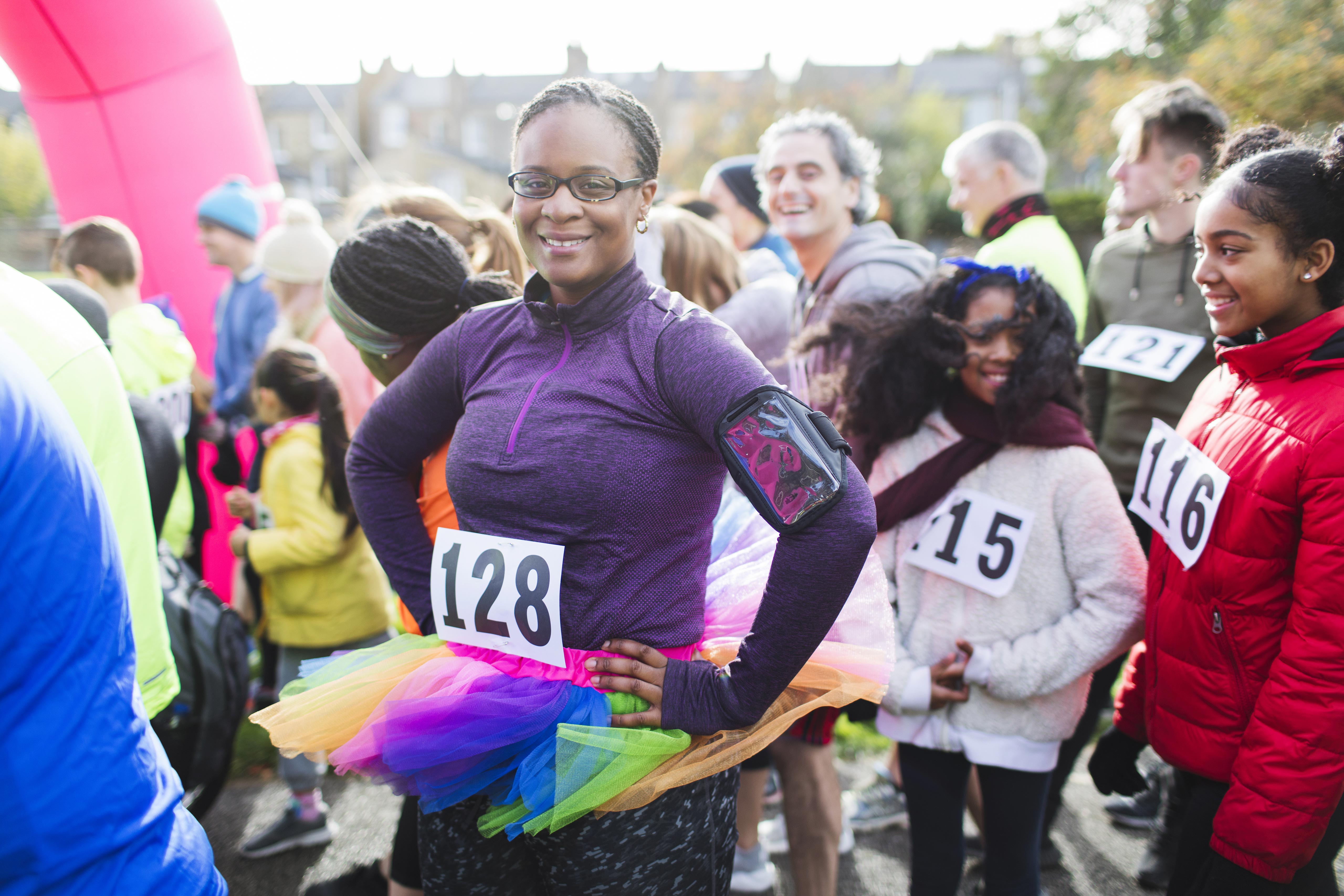 Woman in fancy dress on the start line of a charity race.